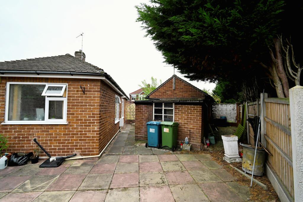 The rear of the bungalow and the store behind the garage
